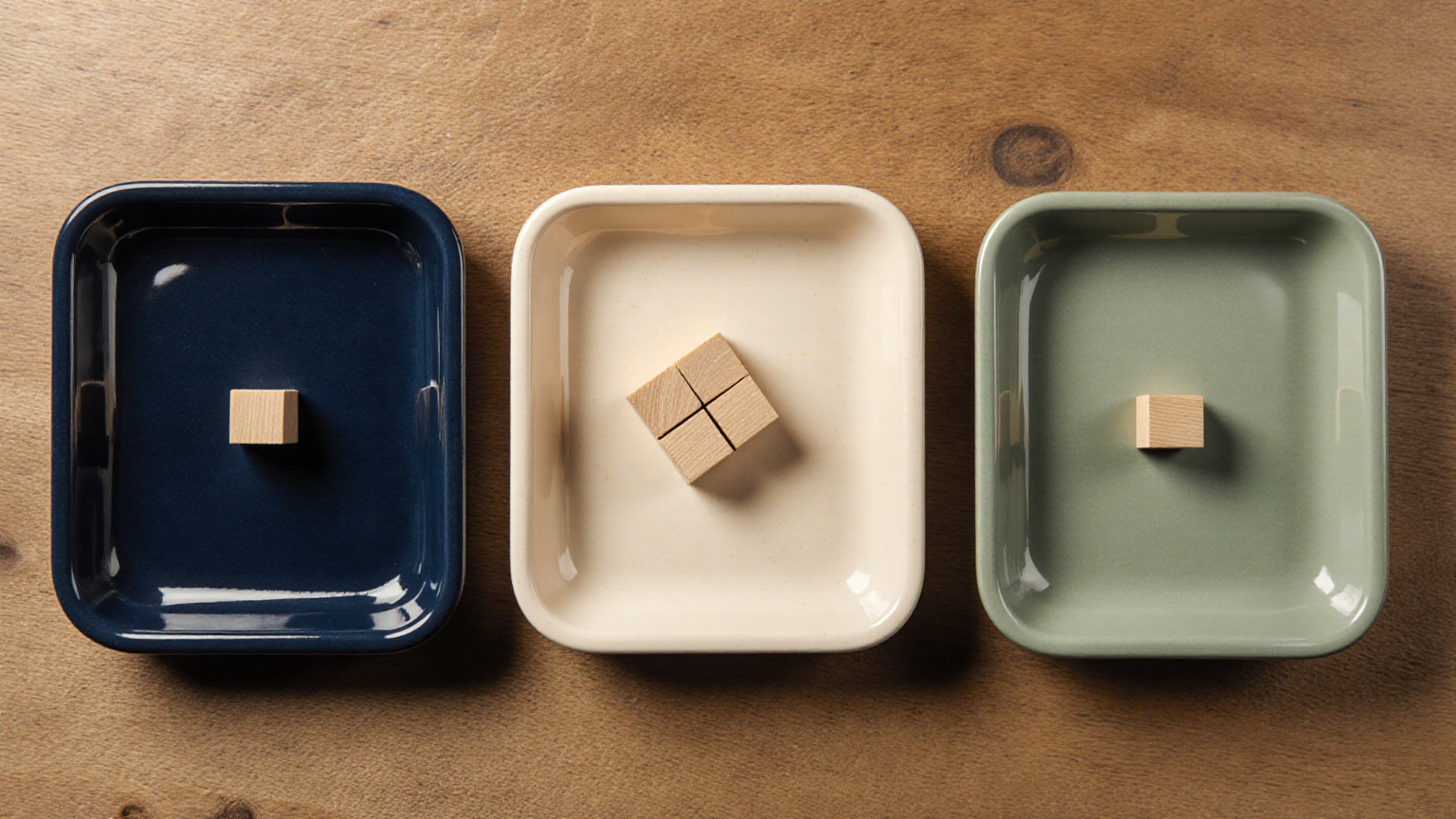 Separate ceramic trays with unmarked wooden blocks representing allocation categories